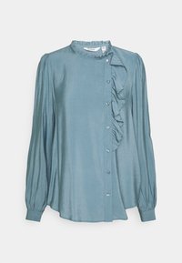 Light blue long-sleeve blouse in smooth fabric featuring a ruffled front, button closure, and a round neckline with a frill.