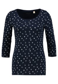 Tummansininen pitkähihaisen paita, jossa on pyöreä kaula-aukko, valkoinen kukkakuosi ja vartaloa myötäilevä malli. Valmistettu pehmeästä, kevyestä kankaasta.