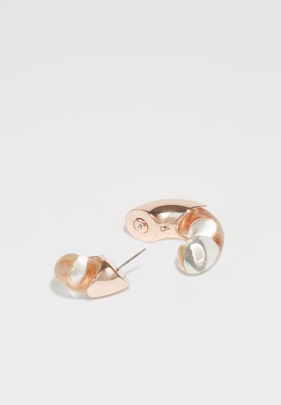 Rose gold metal earrings with a swirling pearl-like design; one earring has a stud backing, while the other is an open cuff style.