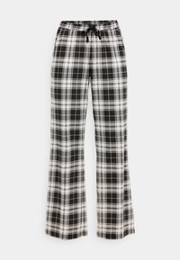 Calças xadrez em preto e branco com um corte solto, cintura elástica e detalhe de cordão. Tecido suave com um padrão quadriculado por toda a peça.