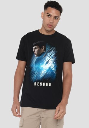 Black cotton t-shirt featuring a graphic print of a character in profile, with blue and white abstract elements and the word "BEYOND" below.