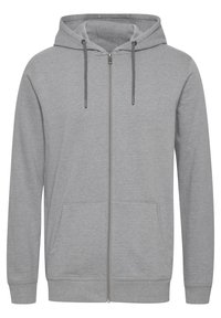 Hoodie gris à fermeture éclair avec capuche à cordon, poches avant, poignets côtelés et texture de tissu douce. Design simple sans motifs ni accents.