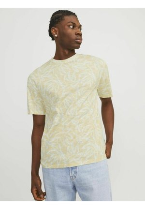 Lysegul T-shirt med korte ærmer og hvidt bladmønster, med rund halsudskæring og blødt, tekstureret stof. Casual pasform.