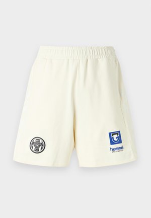 Off-white sports shorts with elastic waistband, side pockets, black circular emblem on left leg, and blue Hummel Sportswear logo on right leg.