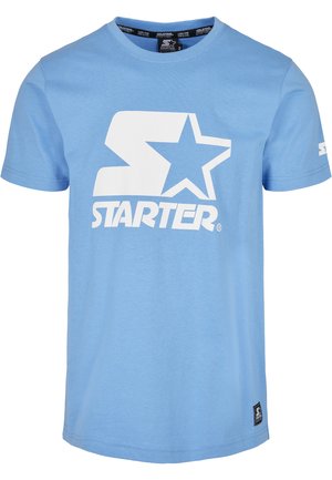Svetlá modrá tričko s krátkym rukávom z bavlny, na prednej strane s veľkým bielym logom "S" a hviezdou, s malou čiernou značkou na lemovaní.