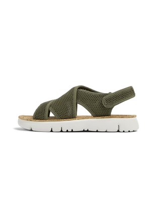 Green mesh sandal with crossover straps, cork insole, and white rubber sole featuring grooves for traction. Adjustable back strap.