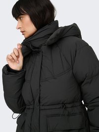 Black puffer jacket with a high collar, adjustable drawstring waist, and quilted texture. Features snap closures and side pockets.