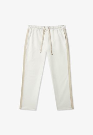 Pantaloni jogger de culoare crem deschis, confecționați dintr-un material moale, cu talie elastică, șnur și dungi laterale bej. Include două buzunare laterale.