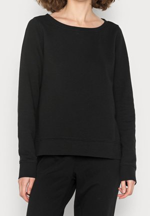 Sweatshirt noir en mélange de coton, doté d'un col rond, de manches longues et d'une coupe décontractée avec des détails de couture le long des bords.