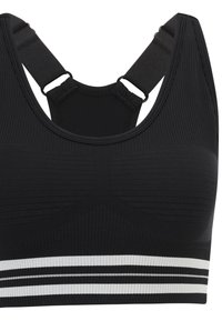 Svart sport-bh med ribbad textur, breda axelband och en svart och vit randig kant i botten. Justerbar axelbandsdetalj inkluderad.