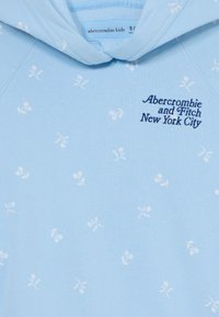 Light blue hoodie featuring a floral pattern in white. It has a front pocket and an embroidered "Abercrombie and Fitch New York City" logo.