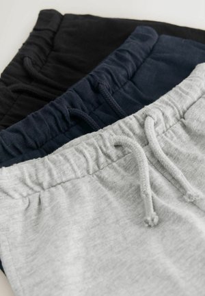 Drei Sweatpants in Grau, Marineblau und Schwarz. Jede verfügt über einen elastischen Bund mit Kordelzug und weichem, strukturiertem Stoff.