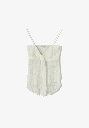 Weißes Spitzentop mit dünnen Trägern, das vorne mit einer Schleife geschlossen wird und ein fließendes, leicht strukturiertes Design aufweist.