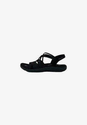 Sandalias negras con tiras, con una suela flexible, que cuentan con múltiples correas trenzadas y una plantilla acolchada para mayor comodidad. Incluye una correa ajustable para el talón.