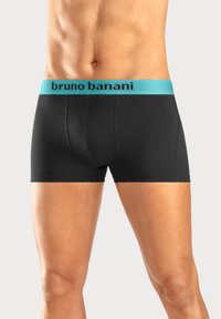 Svart boxerkalsonger med ett ljusblått elastiskt midjeband som har "bruno banani"-logotypen. Slät tyg, åtsittande design, midja till lårlängd.