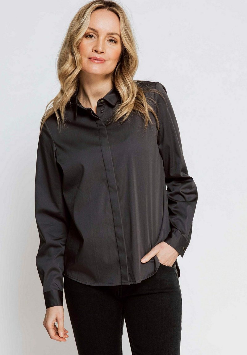 Black long-sleeve button-up shirt with a classic collar, made of smooth fabric, featuring a slim fit and a subtle sheen.