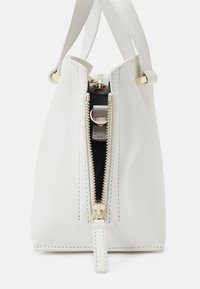White leather handbag with gold-tone zipper and hardware, featuring a structured shape and contrasting navy interior. Two top handles.