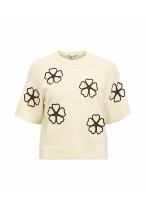 Pull en tricot à manches courtes de couleur crème avec cinq grandes fleurs marron bordées, espacées uniformément sur le devant et les manches.