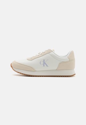 White and beige sneaker with a textured leather upper, suede accents, and a rubber sole. Features a subtle blue "CK" logo on the side.