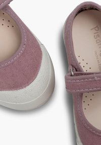 Pink canvas shoes with a white rubber toe. Features a strap with a metal buckle and perforated insole for breathability. Textured sole.