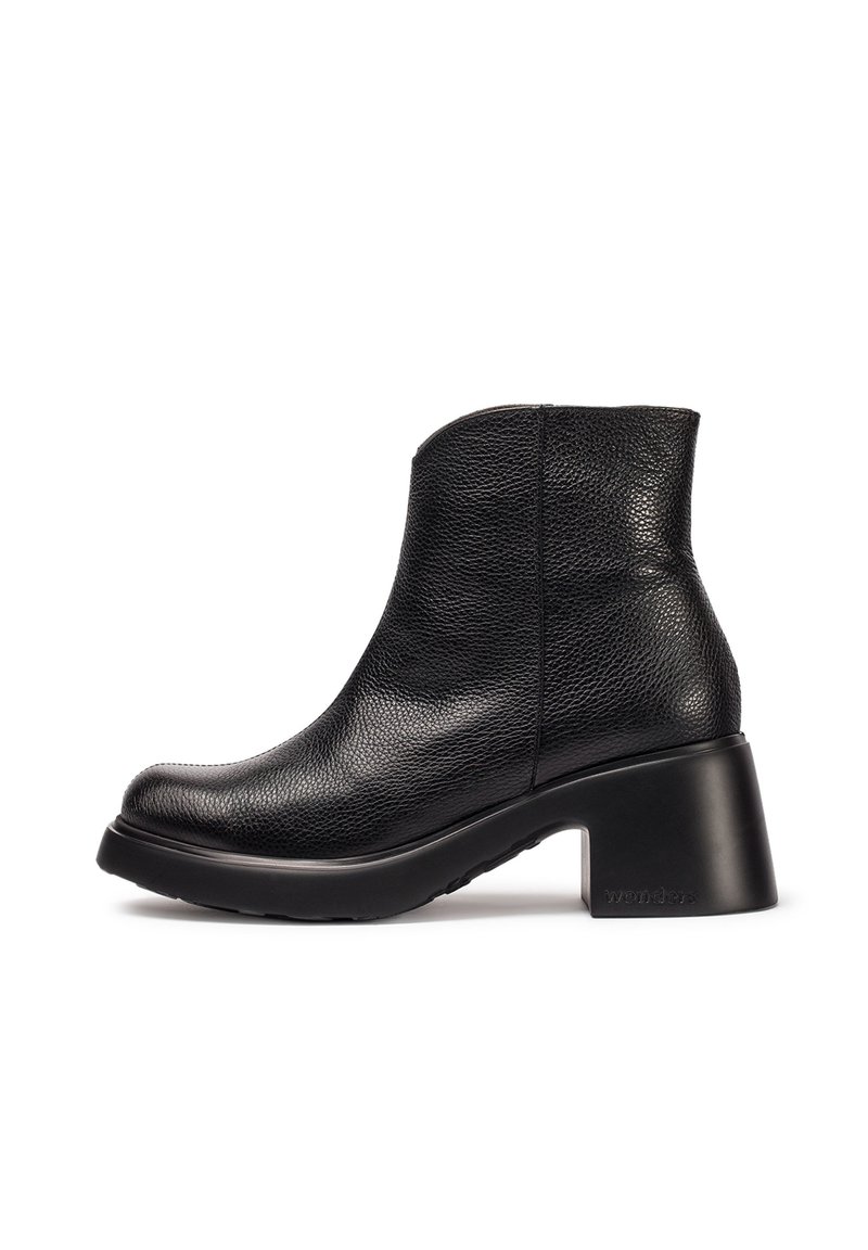 Botas de tobillo negras hechas de cuero texturizado, con punta redondeada, tacón bloque de altura media y suela de goma. Acentos de costura sencilla.