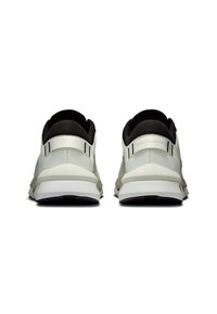 Light grey athletic shoes with a black heel collar, featuring a textured upper, sleek design, and white midsole with a black outsole.