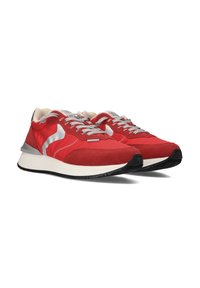Red athletic shoes with suede and mesh materials, silver accents, grey laces, padded collar, and black rubber soles.