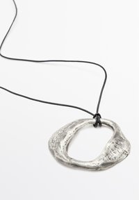 Silver metal pendant with an organic, irregular oval shape, strung on a black leather cord. Textured surface with a polished finish.