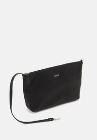 Black leather clutch bag with a textured surface, a zipper closure, and a detachable strap. Features a gold "GUESS" logo on the front.