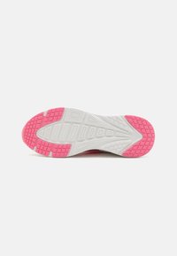 Pink and white sneaker sole with textured grip pattern; athletic design featuring a distinctive raised area for traction.