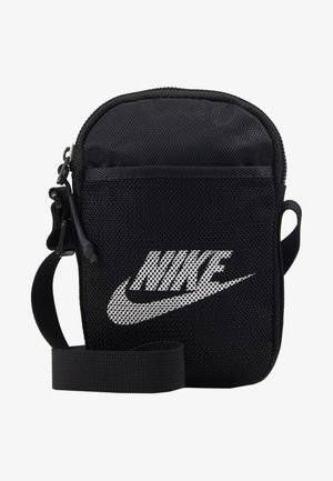 Black mesh crossbody bag with a zip closure, featuring a prominent white Nike logo. Includes a detachable strap for versatility.