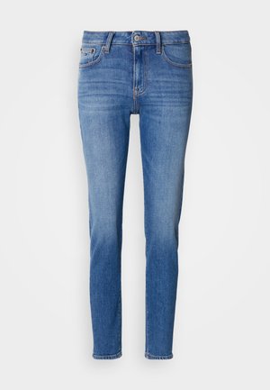 Svetle modré džíny z denimu s úzkým střihem, pěticípým designem, zapínáním na knoflíky a jemným vyblednutím. Prošití podél švů.