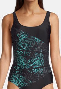 Maillot de bain noir avec un motif floral turquoise, présentant un décolleté plongeant et des bretelles larges. Des détails texturés mettent en valeur le design.