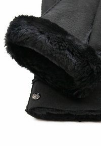 Black fleece garment with a plush, black faux fur cuff. Features a metal snap button accent on the side. Smooth texture overall.