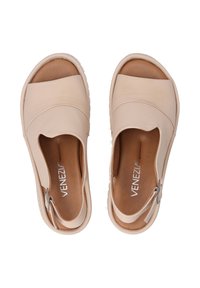 Beige leather slip-on shoes with an open toe design, featuring a smooth texture, subtle stitching, and a white rubber sole.