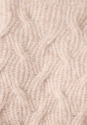 Licht beige gebreide stof met een gestructureerd, golvend patroon. Het materiaal lijkt zacht en pluizig met zichtbare vezels.