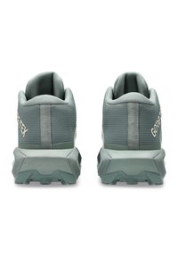 GORE-TEX hiking shoes, gray textile upper, padded collar, rubber sole with traction pattern, rear branding, and reinforced heel support.