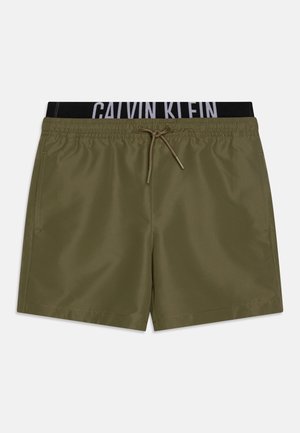 Maslinasto zelene kupaće gaće s crnim elastičnim pojasom koji sadrži bijeli logo "Calvin Klein", zatvaranje na vezicu i bočne džepove.