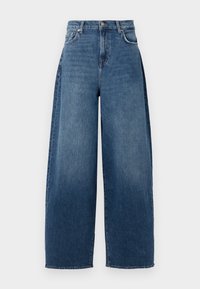 Bredde ben jeans laget av mørkeblå denim. Har høy midje, fem lommer og lukking med nepp. Litt falmet tekstur over hele.