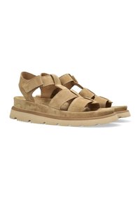 Sandali in suede color tan con più fasce larghe sopra il piede, design aperto sulla punta e una spessa suola bianca caratterizzata da una trama testurizzata.