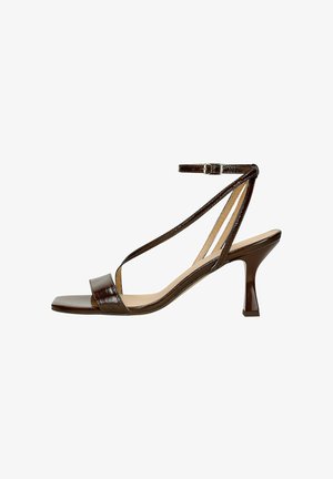 Brown patent leather sandal with a square toe, thin ankle strap, and a curved stiletto heel. Minimalist design with a smooth texture.