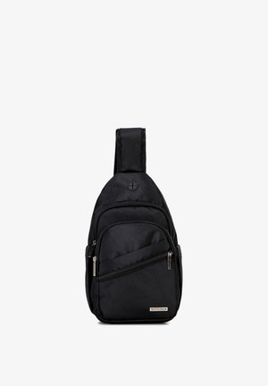 Zaino sling nero con una tracolla larga, più scomparti con cerniera e porta cuffie esterna, etichettato Wittchen nella parte inferiore frontale.