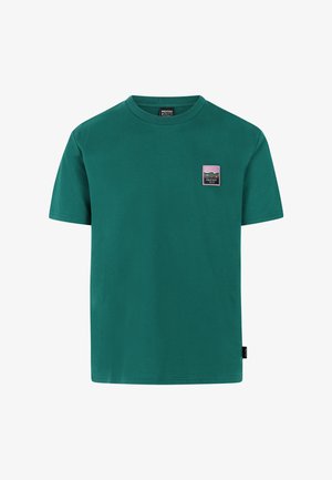 Green cotton t-shirt with short sleeves, round neck, and a small rectangular multi-colored logo patch on the left chest.