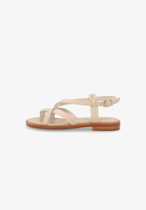 Sandalo basso beige con cinturini intrecciati, fibbia alla caviglia e suola in legno, mostrato di lato su sfondo bianco.