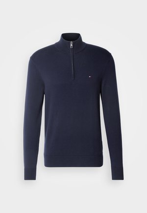 Marineblauer Halbzip-Pullover aus einem weichen Stoff. Mit Stehkragen und kleinem Logo auf der Brust. Gerippte Bündchen und Saum.