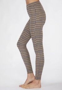 Beige en marineblauwe geraffineerde legging gemaakt van rekbaar materiaal, met een hoge tailleband en een aansluitend ontwerp, geschikt voor casual kleding.