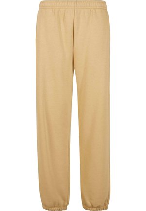 Beige sweatpants van een zachte katoenmix, met een elastische tailleband, zijzakken en elastische boorden bij de enkels.