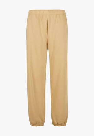 Pantaloni della tuta beige realizzati in morbido misto cotone, con vita elasticizzata, tasche laterali e polsini elastici alle caviglie.