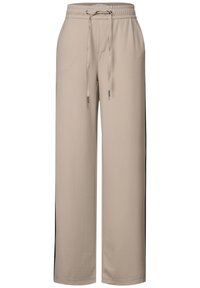 Beige sweatpants with an elastic waistband, adjustable drawstring, side pockets, and contrasting black side panels. Soft, lightweight material.