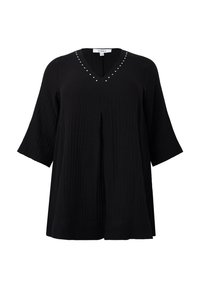 Zwarte tuniek met een V-hals en korte mouwen. Kenmerkt zich door decoratieve studs langs de halslijn en een gekreukelde textuur. Losse pasvorm.